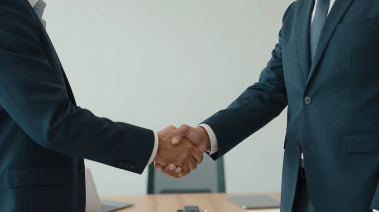 Two professionals in an International / Global office shaking hands over a meeting table. The composition is clean and modern, highlighting trust and professional partnership. Palette includes deep blue and dark teal.