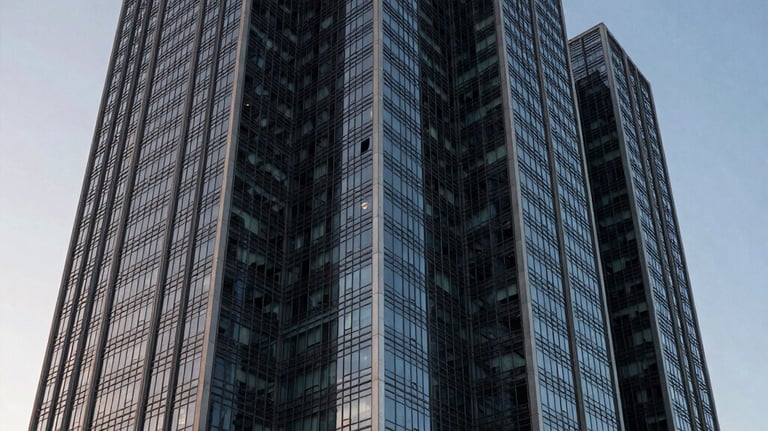 The facade of a contemporary corporate building in Brazil at dawn. Sharp geometry, glass and steel, conveying authority and permanence.