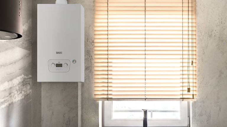 A white Baxi wall-mounted combi boiler installed in a modern kitchen next to a window with blinds