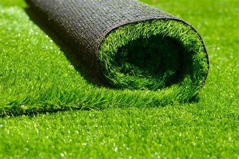 A roll of vibrant green artificial grass turf being installed for a low-maintenance lawn.