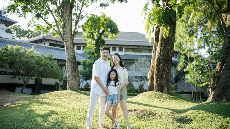 Family standing together on the resort lawn during a family photography session at InterContinental Bali Resort