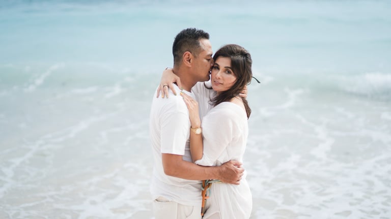 Couple embracing by the ocean during a beach session at Karma Kandara Bali  
