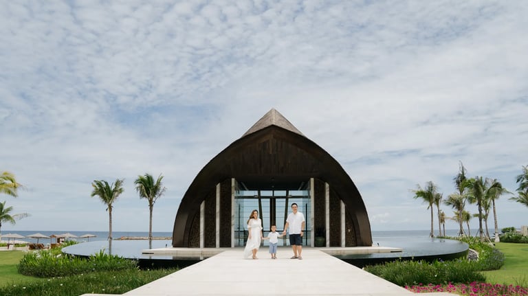 Family portrait at the entrance of the iconic chapel at The Apurva Kempinski Bali