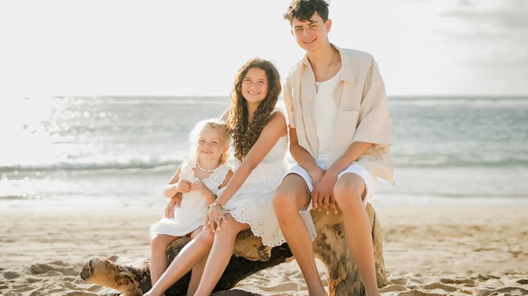 Family portrait captured on the beach during sunset at Ayodya Resort Bali in Nusa Dua