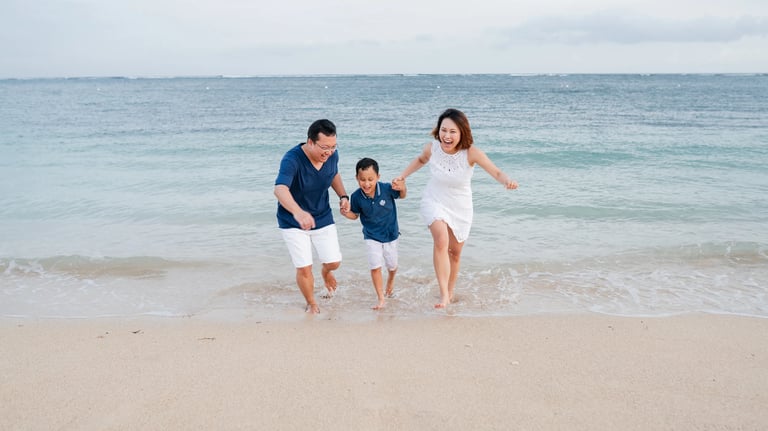 Family photography session walking on the beach at The Mulia Nusa Dua Bali