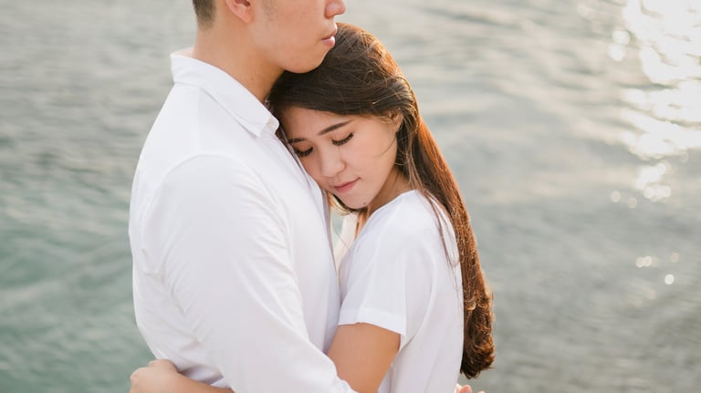 Intimate couple proposal moment by the ocean at Melasti Beach Bali