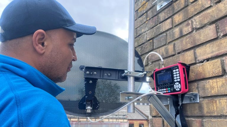 man installing sky dish