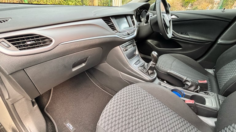 a car dashboard with a steering wheel and a steering wheel