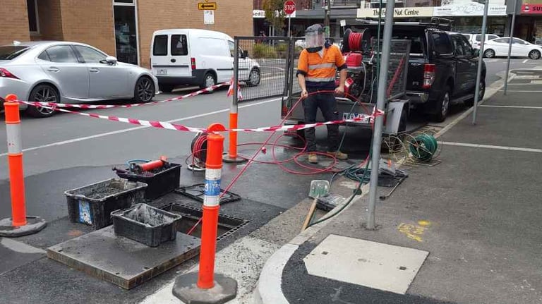 plumber unblocking stormwater pipes
