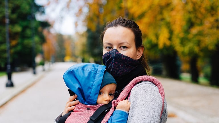 mom holding toddler, sharing stories, smiling at home