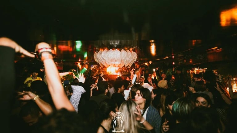 a crowd of people standing around a large fountain