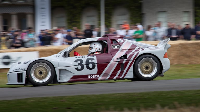 A side motion view of an RS200 driving down the hill at the Goodwood Festival of Speed 2015