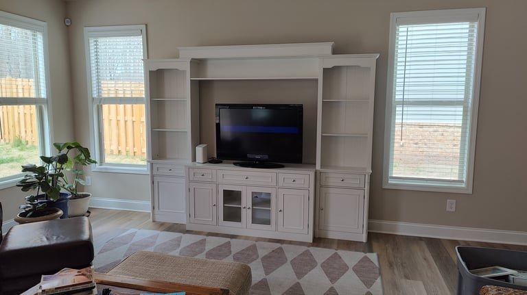 Professional living room furniture assembly with sofa, coffee table, and TV stand in a North Atlanta