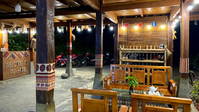 a homestay with a wooden table and chairs