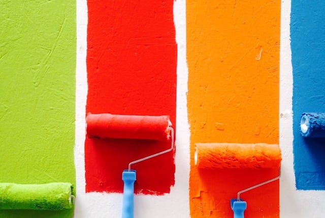 rows of paint with rollers in different colours