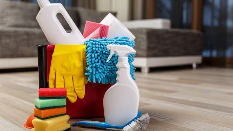 a bucket full of cleaning supplies on a wooden floor