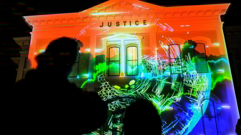 A dramatic nighttime scene where a historic building is brought to life with vibrant 3D Mapping