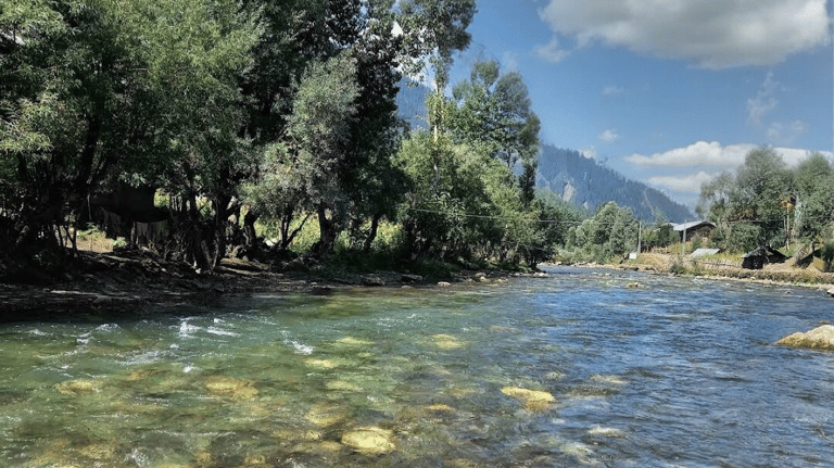 a kunhar river with Himalayan mountains in the background