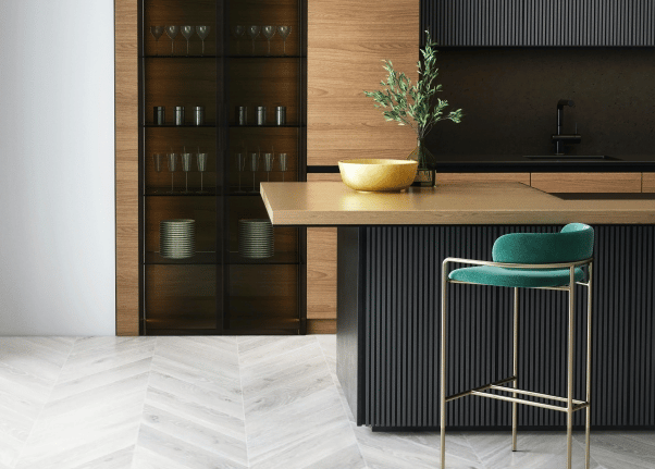a kitchen with a bar stool and a bar stool