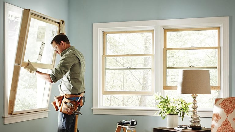 a man in a window sill holding a window