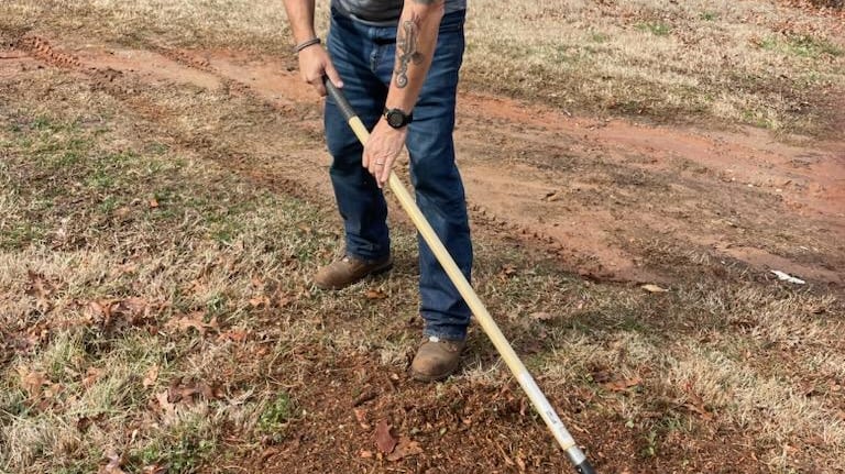 Cleaning up after stump grinding service.