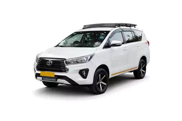 White Toyota Innova Crysta one way taxi by Saini taxi services with a luggage carrier rack