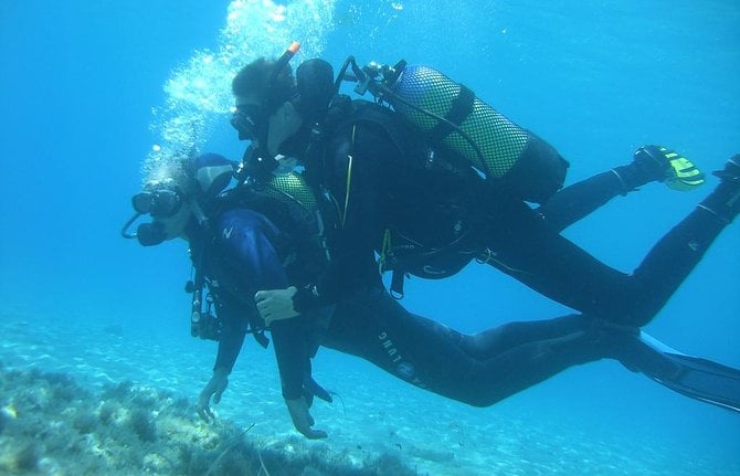 two people are scuba divers in the water