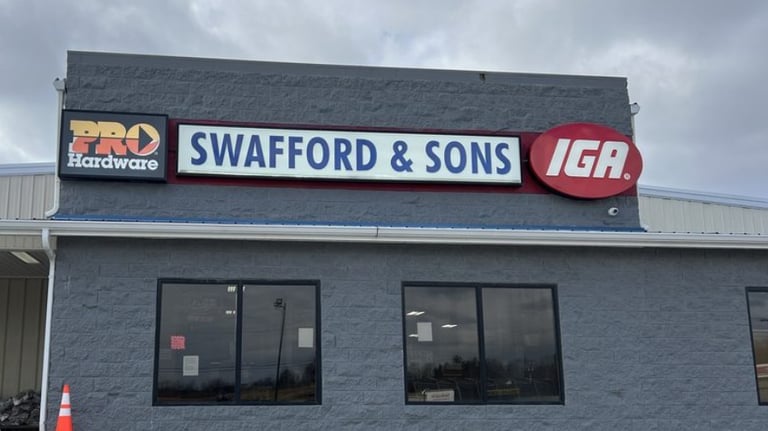 Exterior of Swafford and Sons IGA grocery store and Pro Hardware building with red and blue signs.