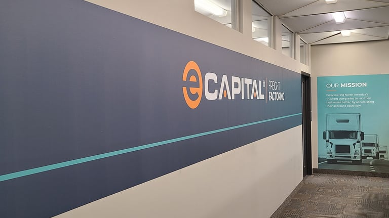 An interior wall with a wall graphic that says "e-capital "