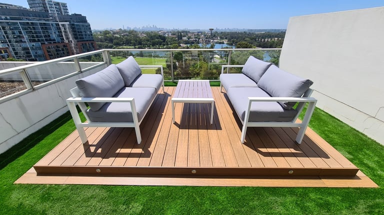 Composite deck on a rooftop with an artificial grass surround