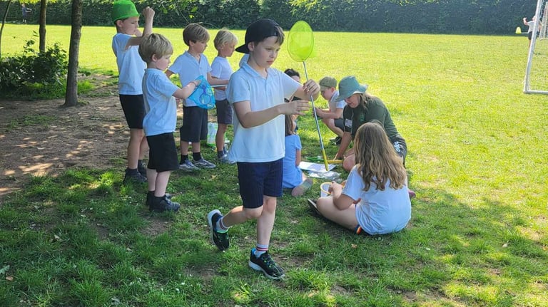 a group of children playing with bug nets