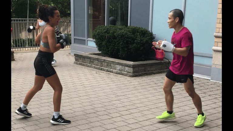 A man and woman are exercising in a gym.