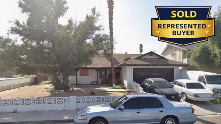 a car parked in front of a house with a sold sign
