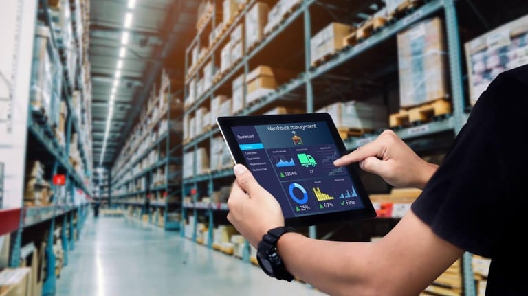 a man in a warehouse with a tablet and a tablet