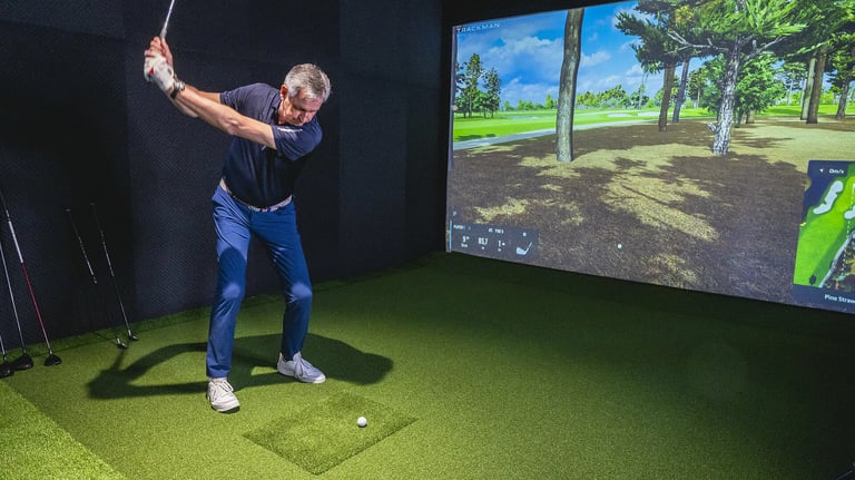 Luxury indoor golf simulator installation with impact screen and 4K projector in a London home.