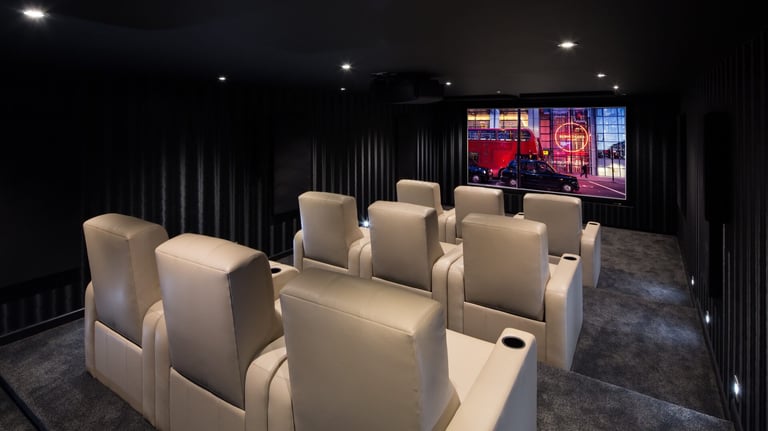 Bespoke home cinema installation with tiered seating and 4K projection in London.