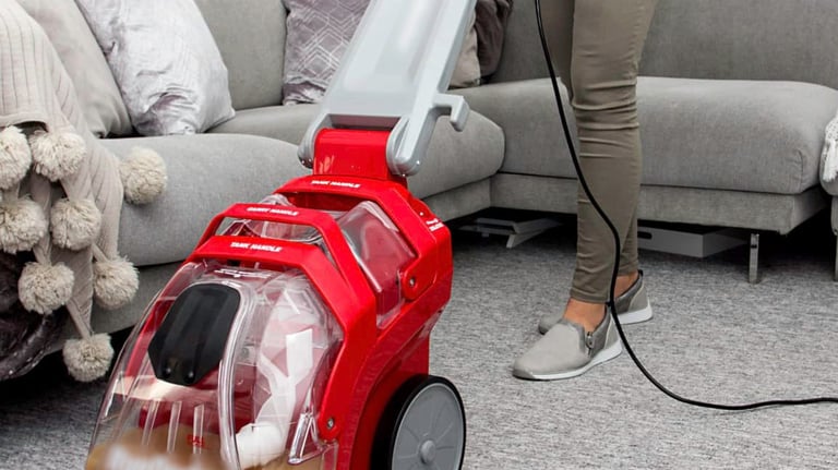 carpet rug cleaning a woman is cleaning a carpet with a vacuum
