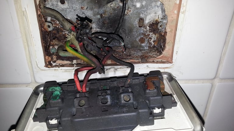 Burnt kitchen socket caused by overheating found during electrical fault finding in Grays
