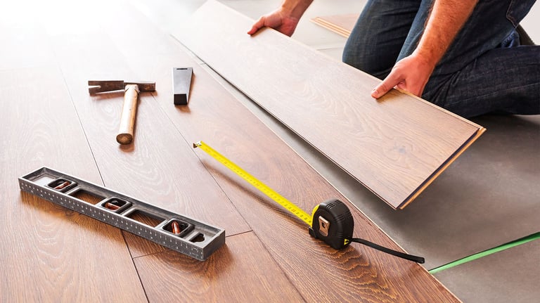 Hardwood floors installer working on new floors. Hardwood floor services. Hardwood near Everett.
