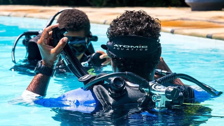 two people in scuba diving suits in a pool