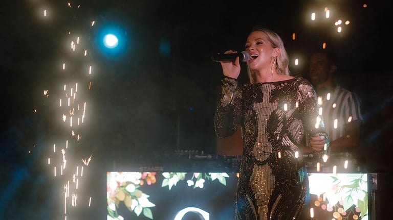 High-energy wedding party entertainment in Italy featuring Natalie Page with live sparks and house v