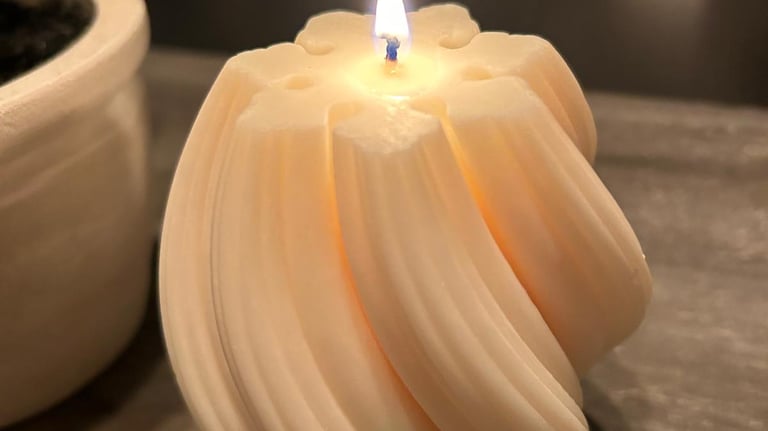 White twisted candles lit over a grey board
