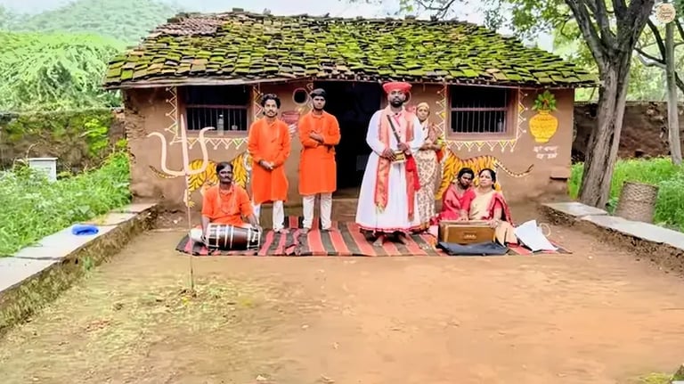 Folk artists dressed in colorful attire before a dance show at Shilpgram craft village.