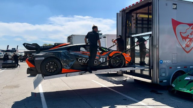 a man is loading a car into a trailer