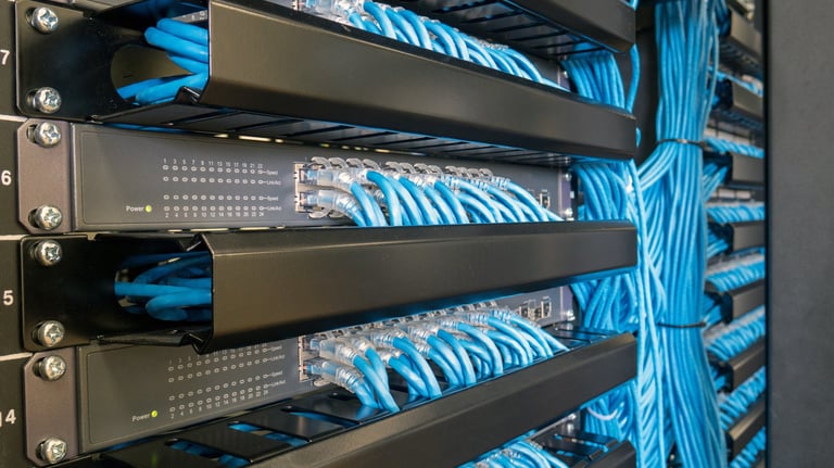 a bunch of cables connected to a server rack