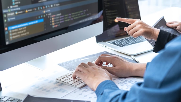 a man is typing on a computer screen