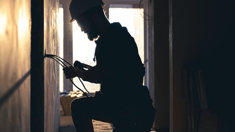 a man in a hat and a hat is sitting on a stool