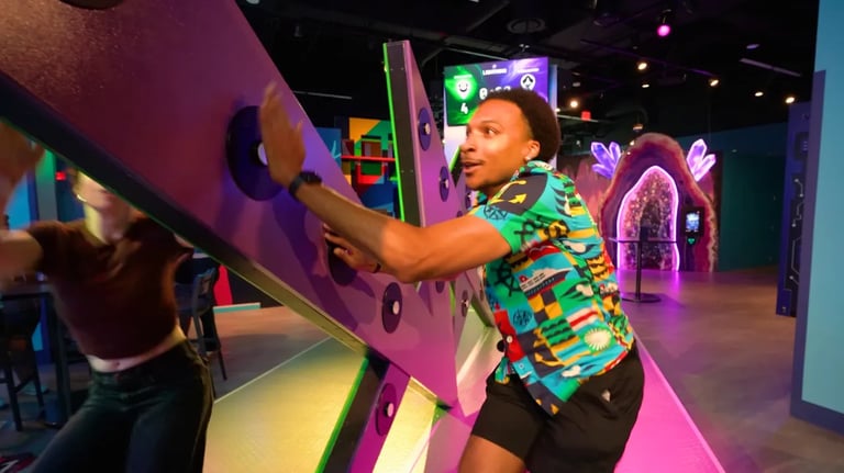 A guest playing a high-energy reaction game at Level 99 Disney Springs, hitting glowing buttons on a machine.
