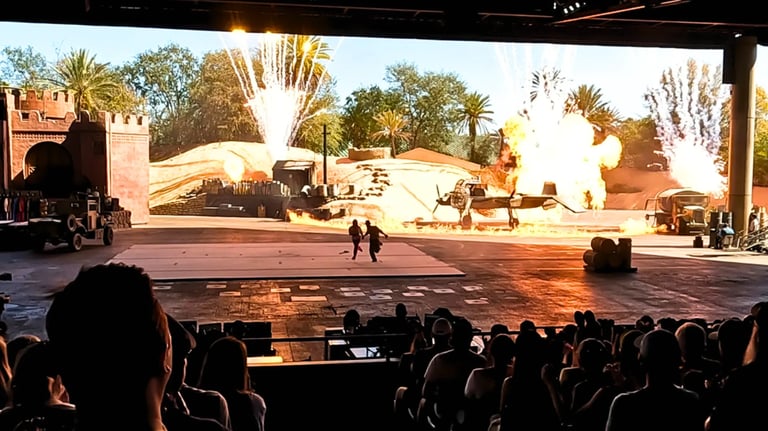 Audience watching a massive airplane explosion during the finale of the Indiana Jones Stunt Spectacu