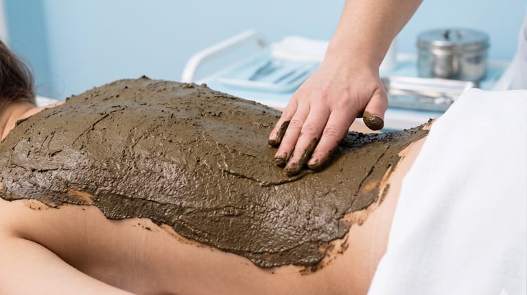 Therapist applying a natural Herbal Salve to the back to improve wellness.